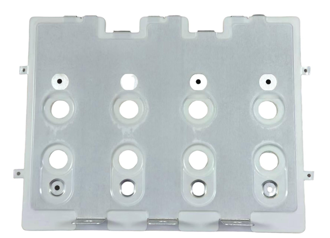 Stamped and formed busbar part showing hole patterns and bend